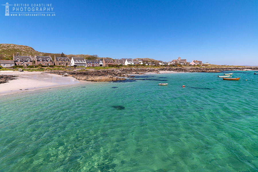 Isle of Iona, crystal clear turqoise water, boats, white sandy beach, houses over looking sea