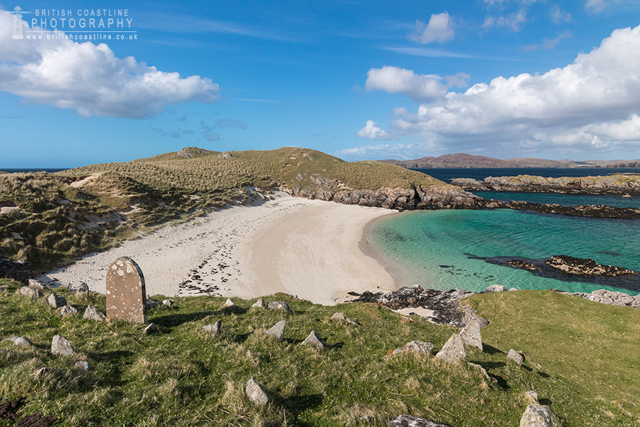 Little Bernera, Outer Hebrides, Grassy verge foreground with gravestone looking over sandy beach, tropical waters, sand dunes