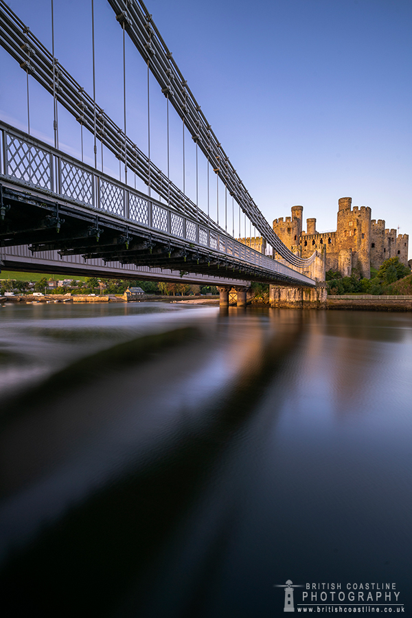 conwy castle drawbridge leading you in to conway castle under an early morning purple sky